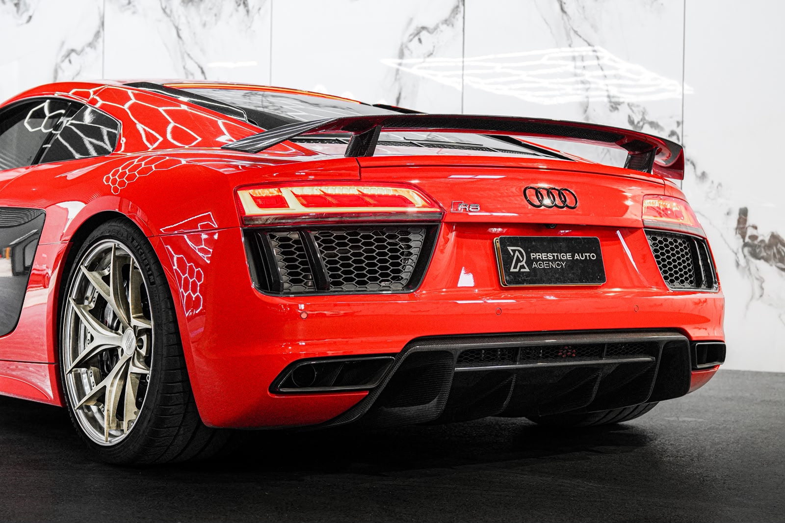 Red Audi car with a visible logo on a white background