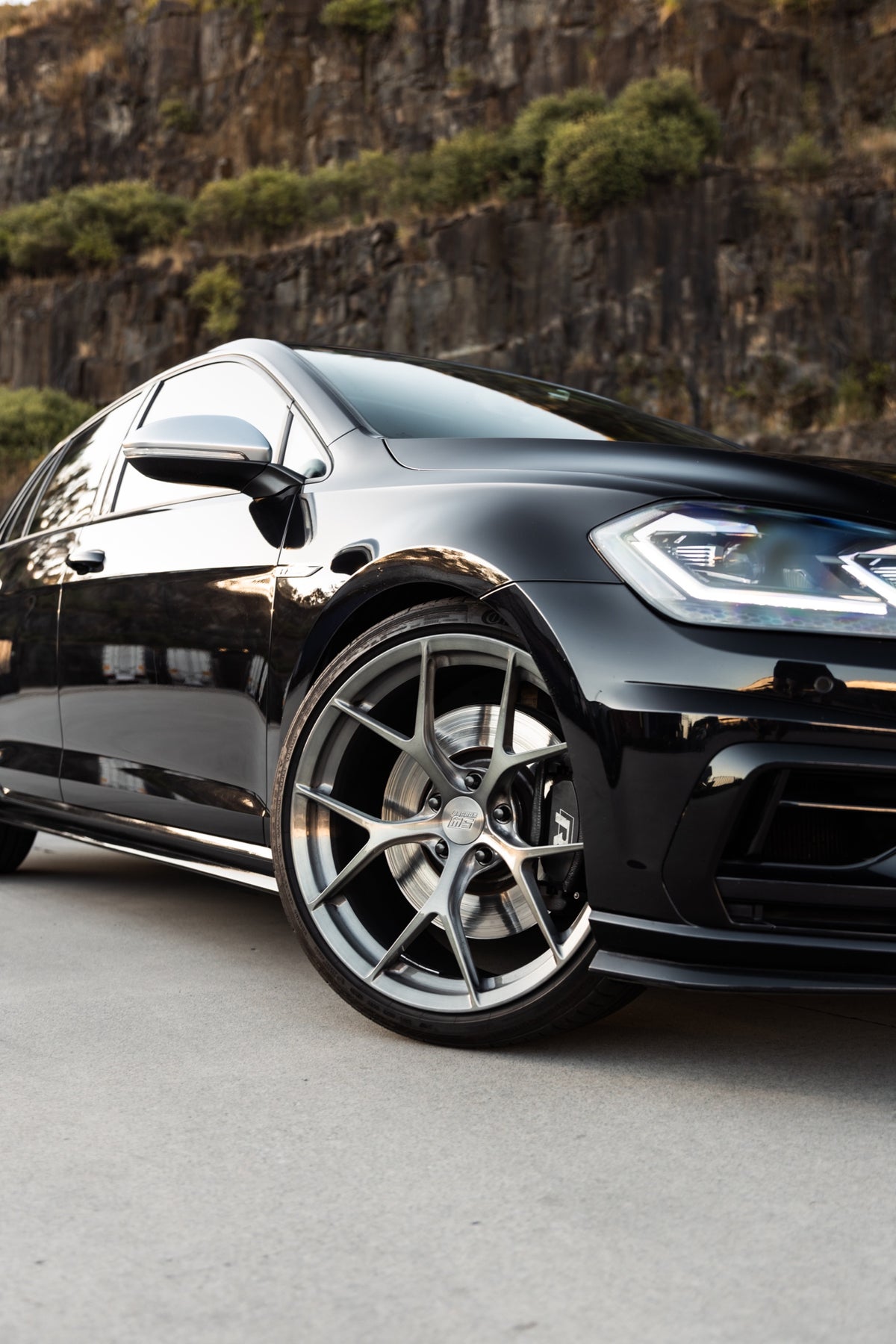 SWF03 forged wheels in Brushed Grey on a black Volkswagen Golf R Mk7.5, front close-up