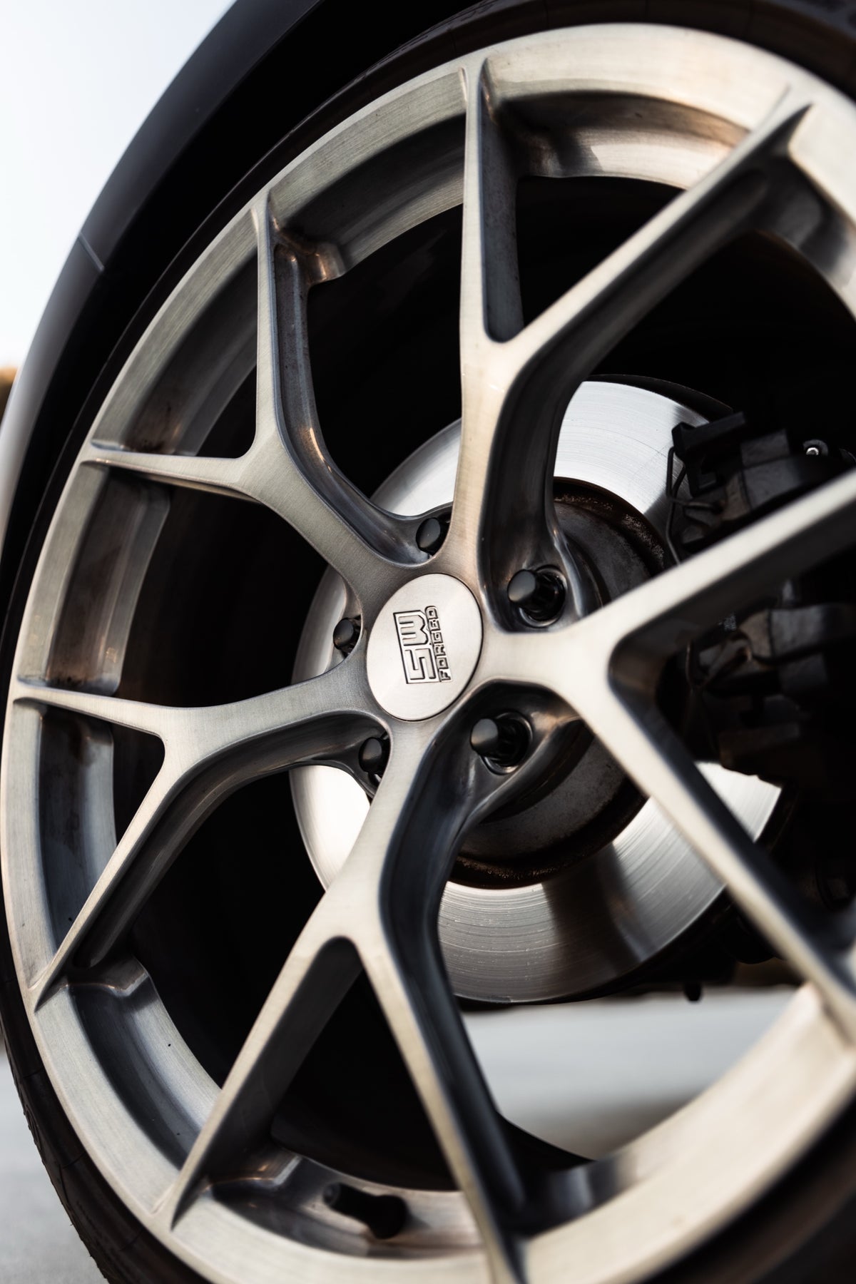 SWF03 forged wheels in Brushed Grey on a black Volkswagen Golf R Mk7.5, spoke and centre cap detail