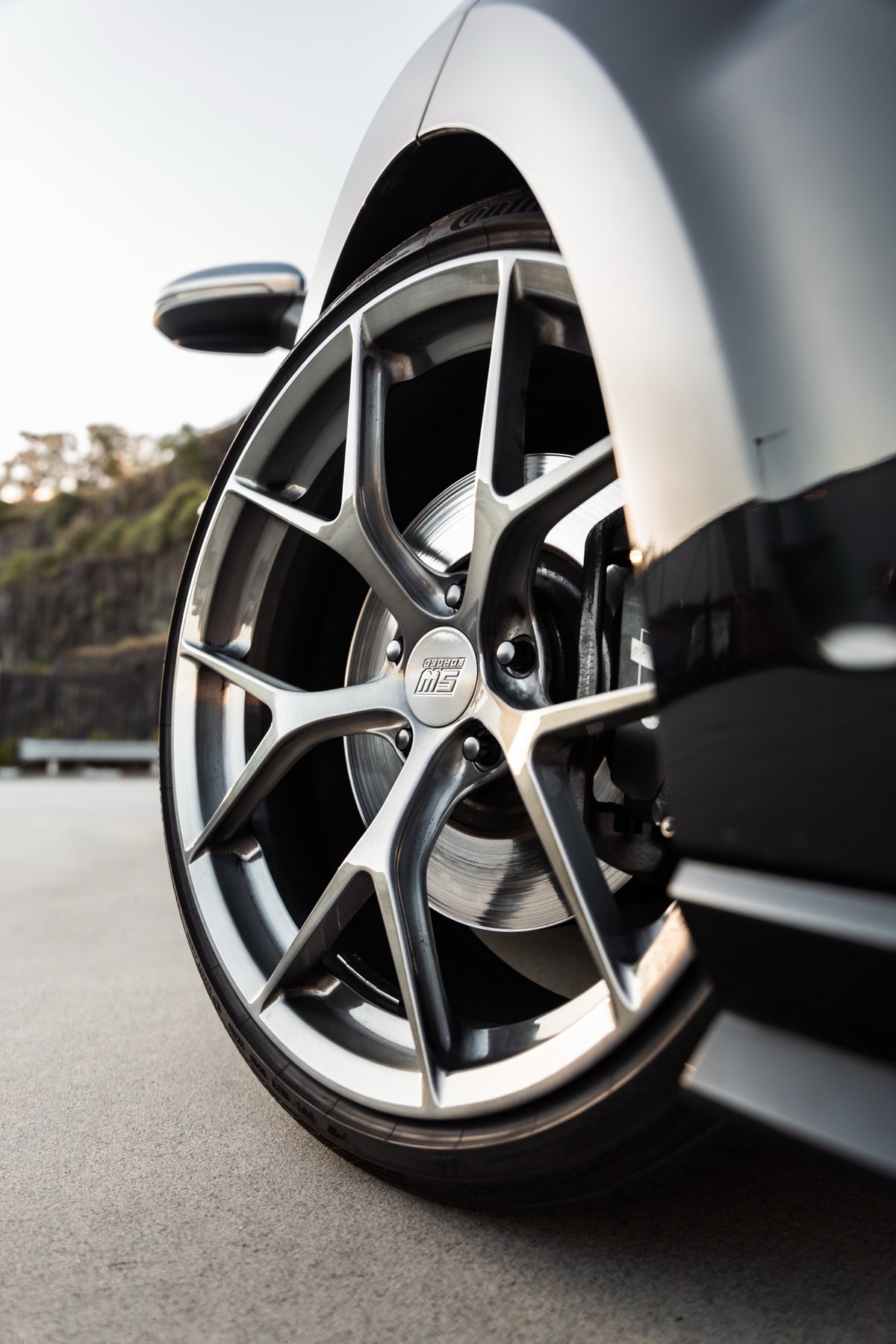 SWF03 forged wheels in Brushed Grey on a black Volkswagen Golf R Mk7.5, front wheel, low angle
