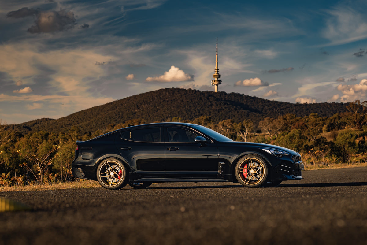 SWF04 forged wheels in Satin Bronze on a black Kia Stinger, side profile