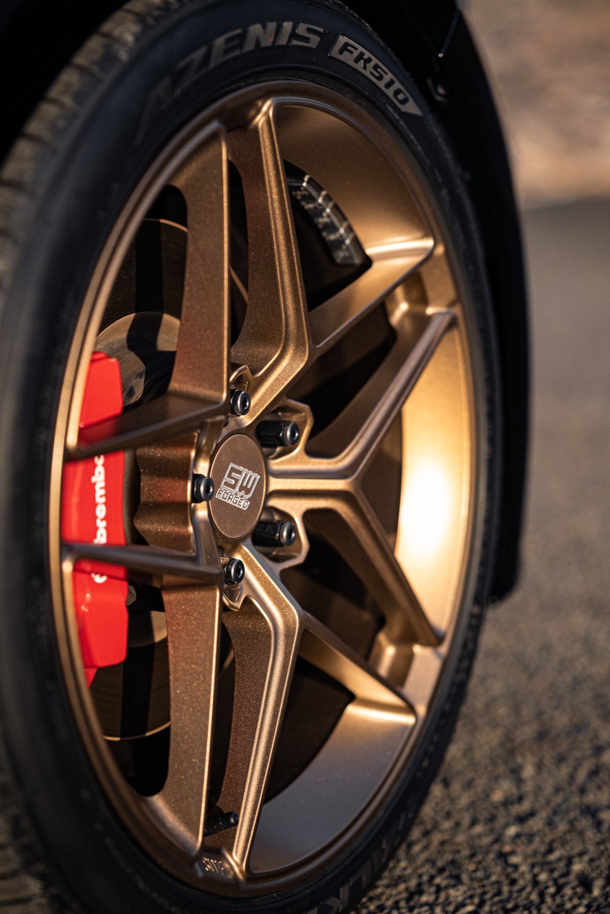 SWF04 forged wheels in Satin Bronze on a black Kia Stinger, wheel and caliper detail
