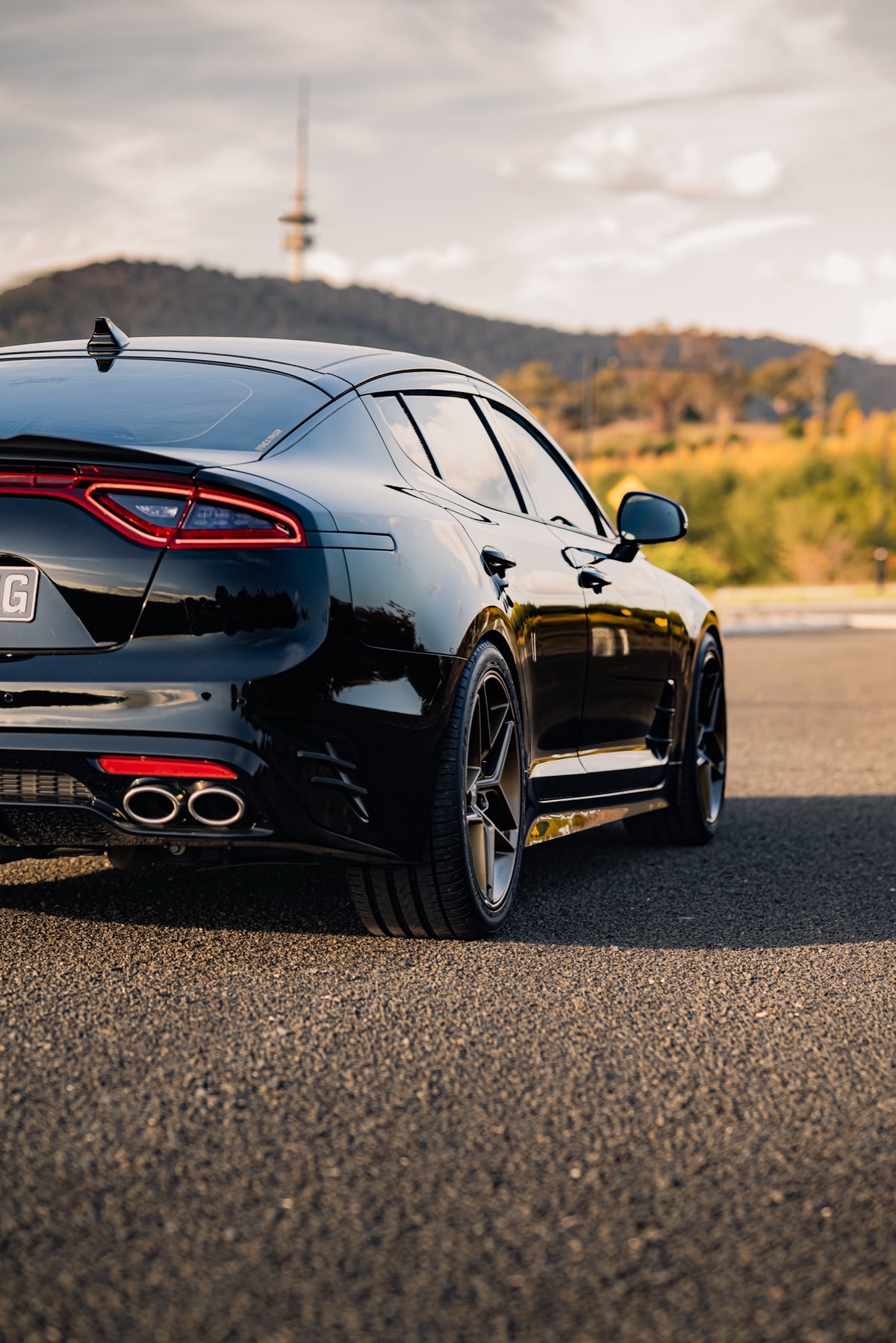 SWF04 forged wheels in Satin Bronze on a black Kia Stinger, rear three-quarter